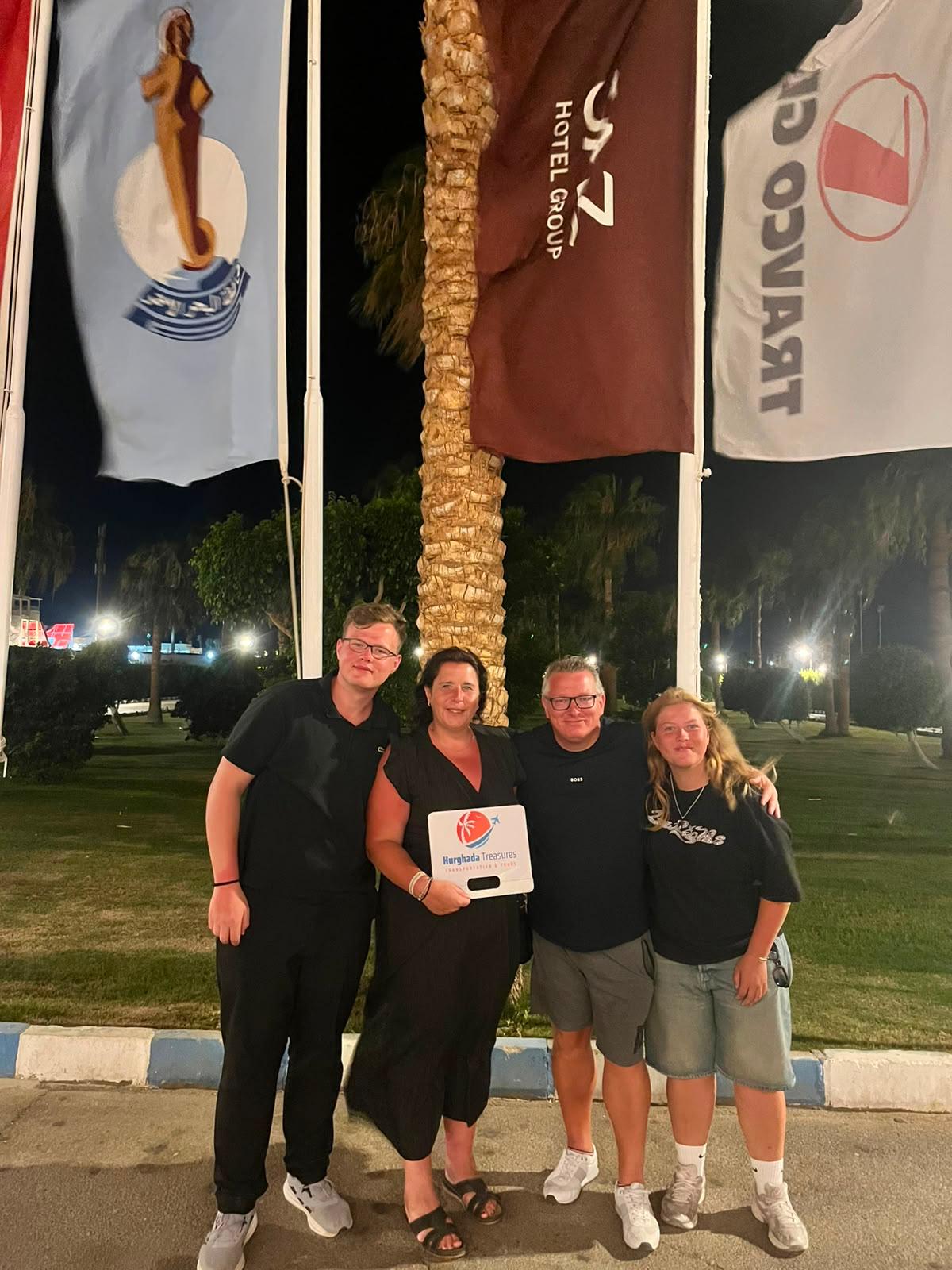 Family in front of their Hurghada hotel with the Hurghada Treasures sign