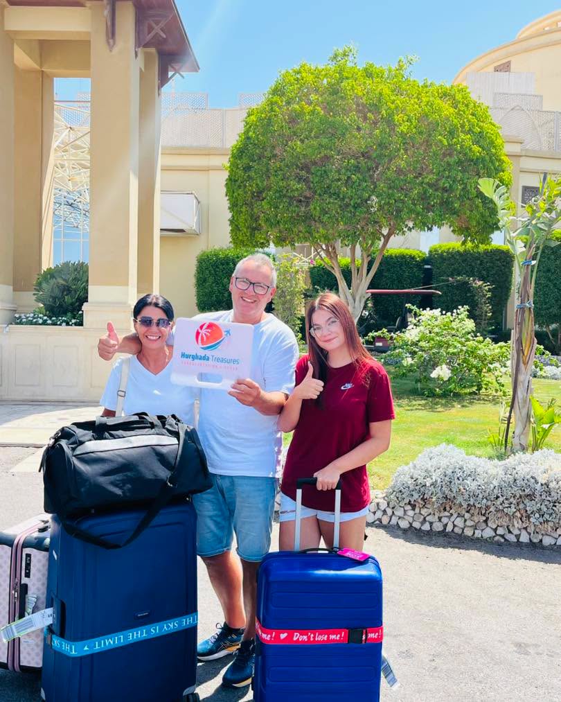 Family with their suitcases at their hotel before a Hurghada airport departure transfer