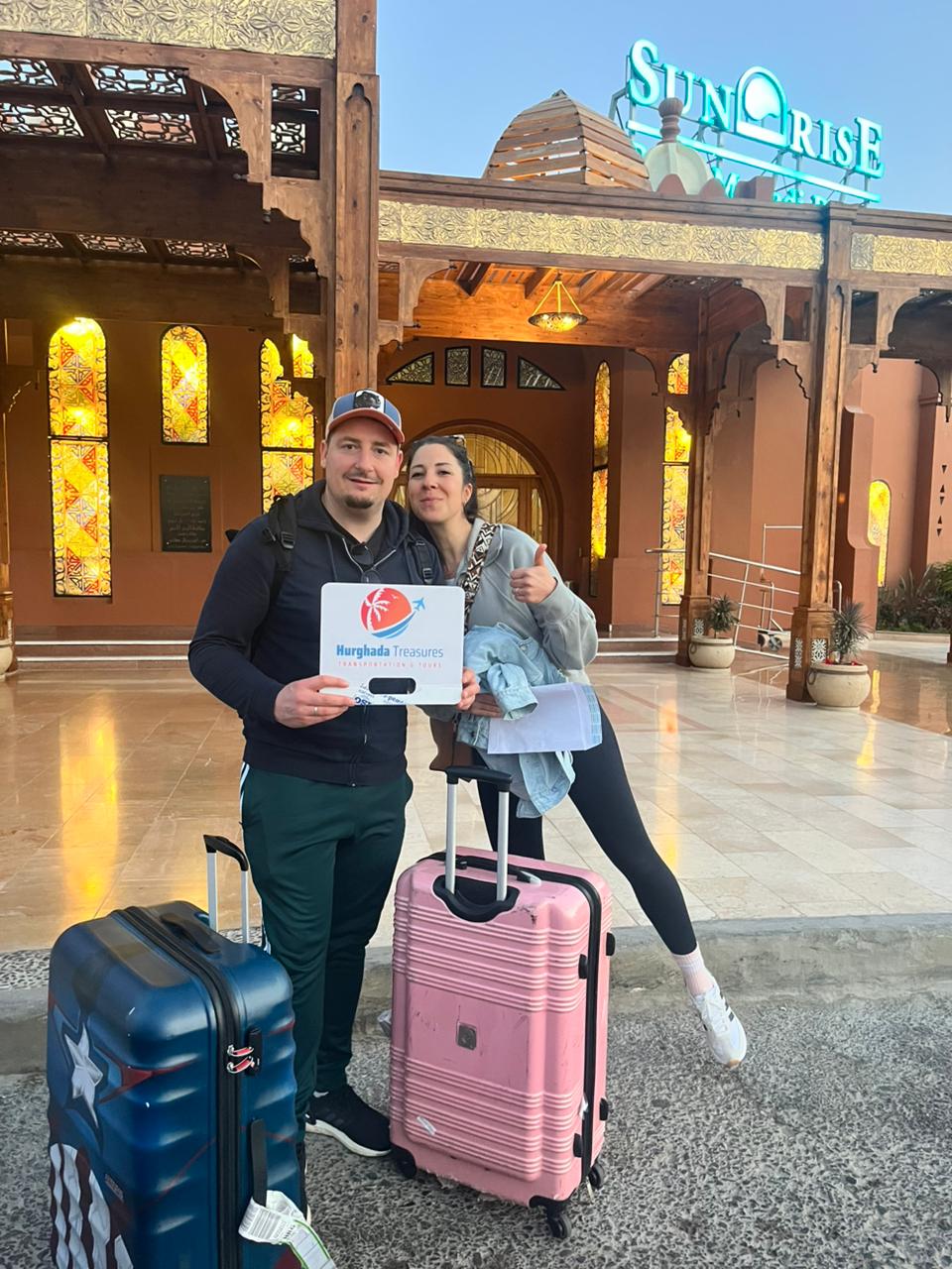 Couple with suitcases at Sunrise Royal Makadi after a private airport transfer