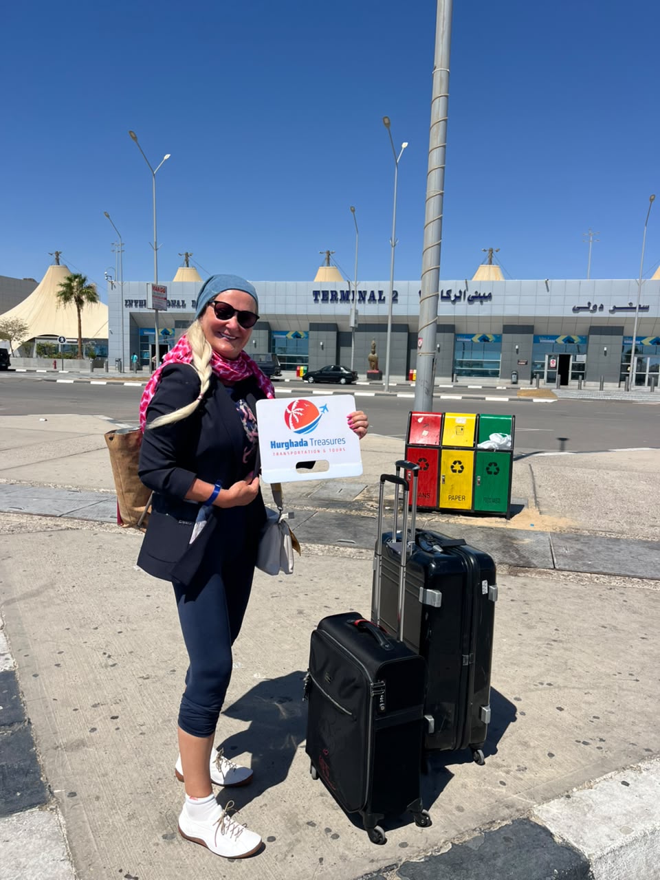 Guest with her luggage met by Hurghada Treasures outside Terminal 2 in Hurghada